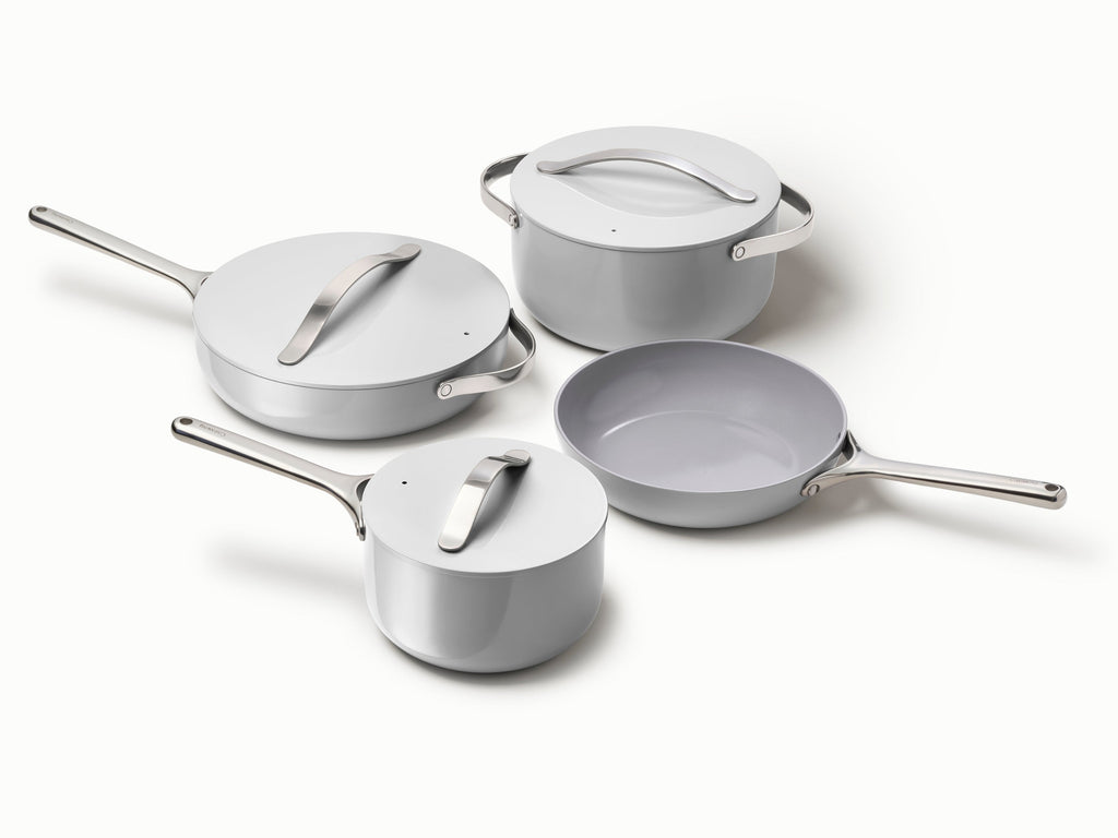 Caraway ceramic cookware set in Gray with four pans, three matching lids.