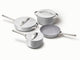 Caraway ceramic cookware set in Gray with four pans, three matching lids.