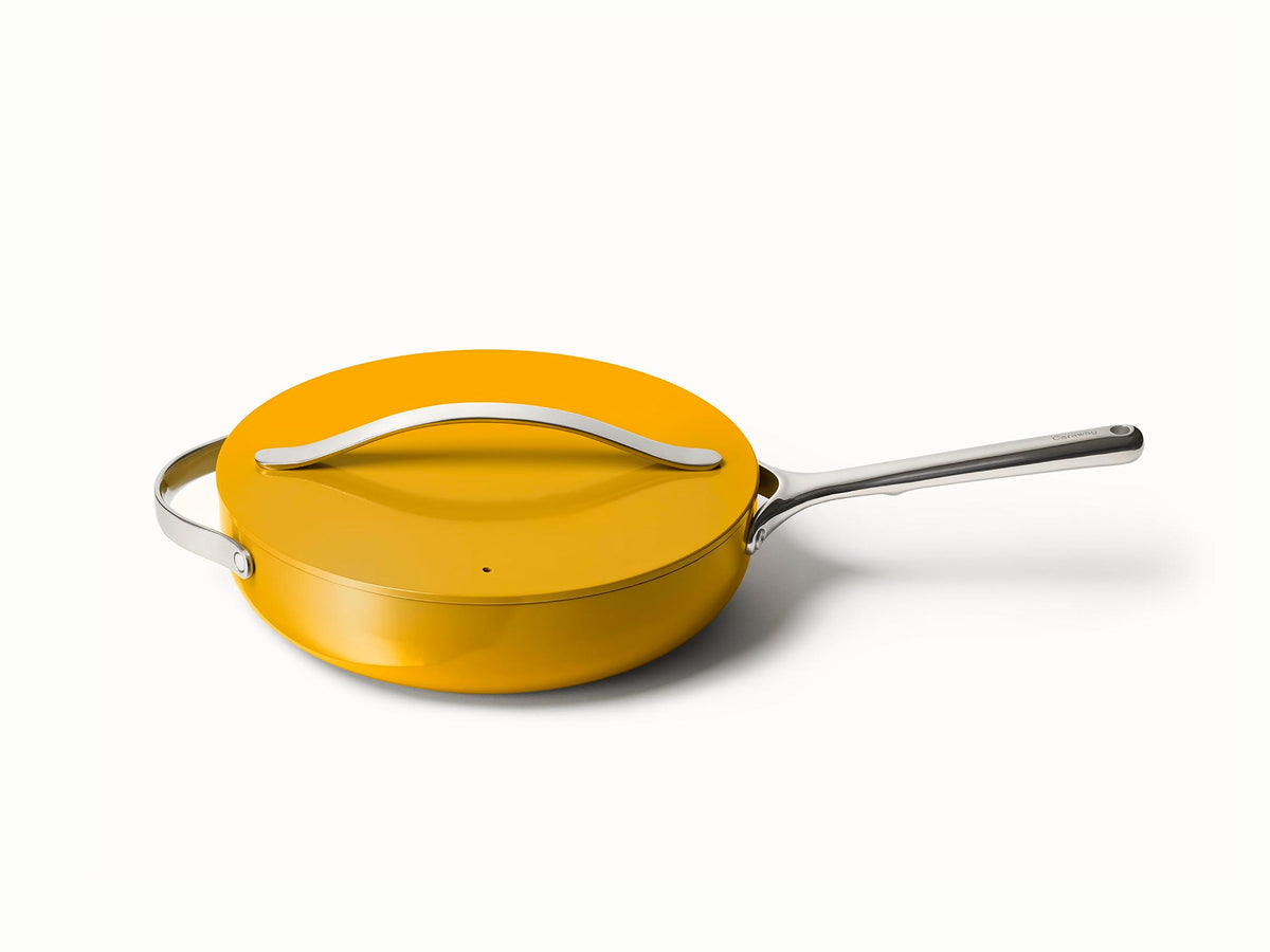 Caraway ceramic sauté pan in Marigold with a matching lid.