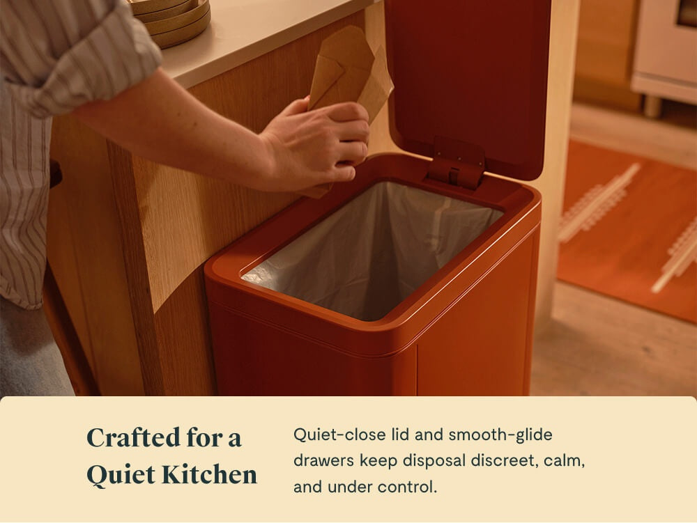 Person closing a Clay trash can lid beside a kitchen island.