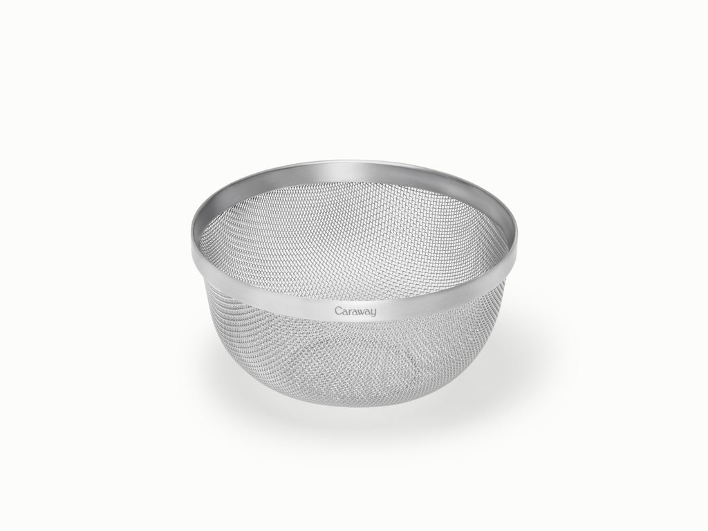 Caraway small stainless steel strainer with fine mesh sides.
