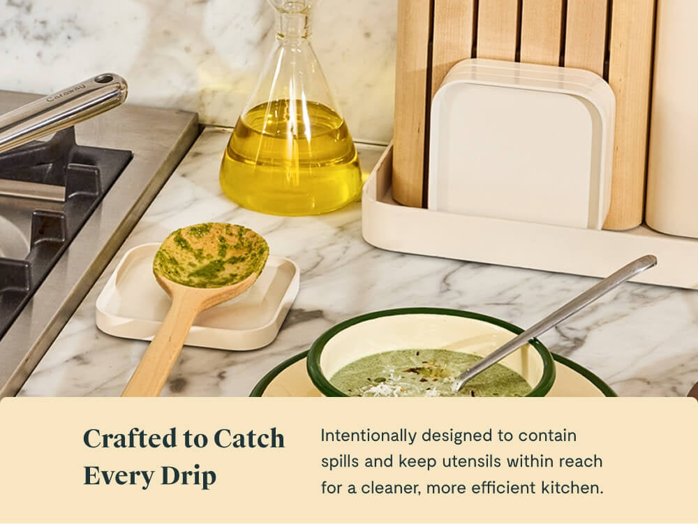 Caraway cream spoon rest holding a wooden utensil beside a bowl and stove.