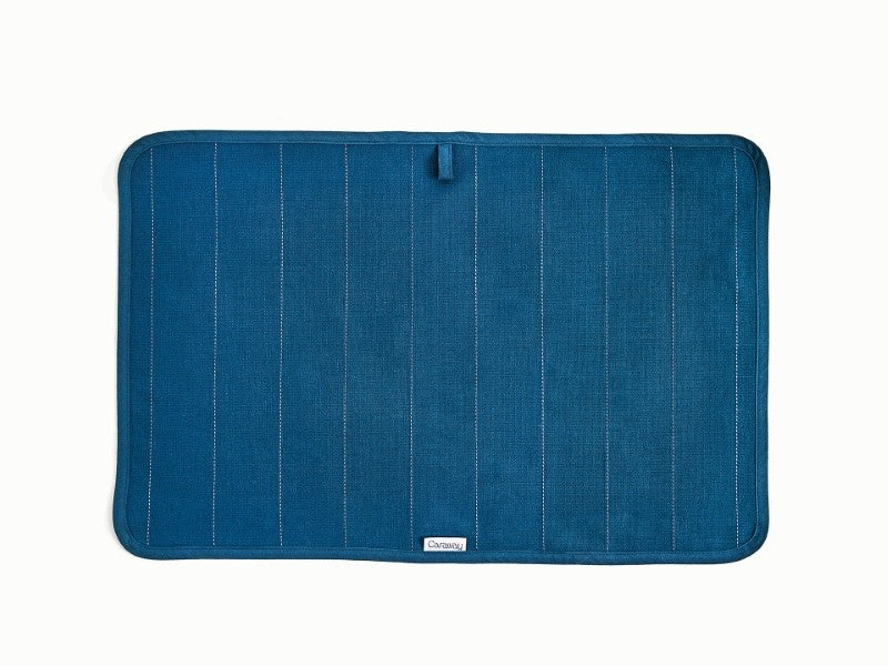 Caraway Navy tea towel laid flat to show the fabric and stitching.